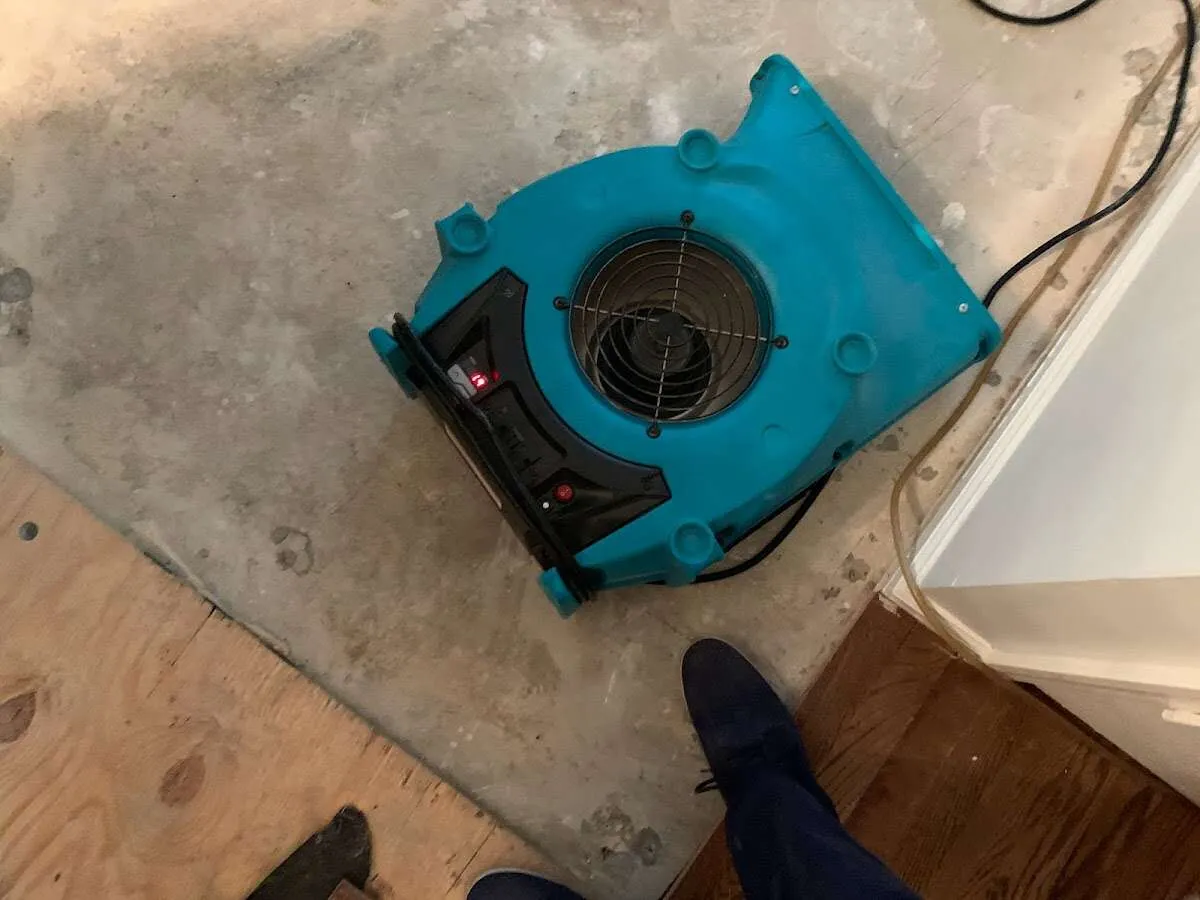 Air mover drying subfloor during Commercial Water Damage Restoration in Winston-Salem